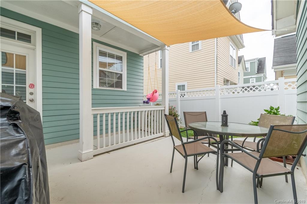 4222 Vance Road North Huntersville, NC 28078 - Photo 30 of 36 a view of a patio with a table and chairs under an umbrella