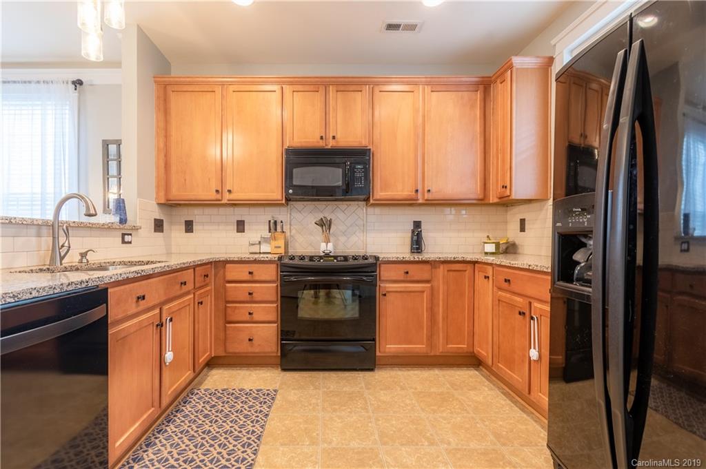 4222 Vance Road North Huntersville, NC 28078 - Photo 7 of 36 a kitchen with stainless steel appliances granite countertop a stove a sink and a refrigerator