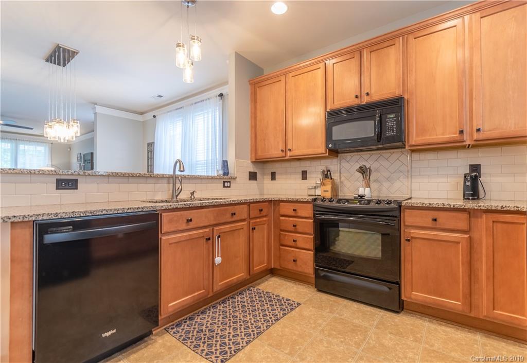 4222 Vance Road North Huntersville, NC 28078 - Photo 8 of 36 a kitchen with stainless steel appliances granite countertop a stove sink microwave and cabinets