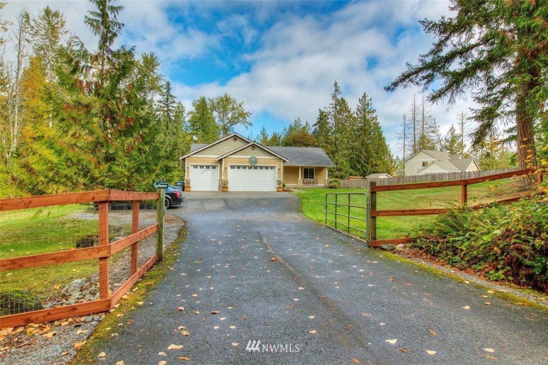 5809 Stringtown Road East Eatonville, WA 98328 - Photo 1 of 28 a front view of a house with a yard and garage