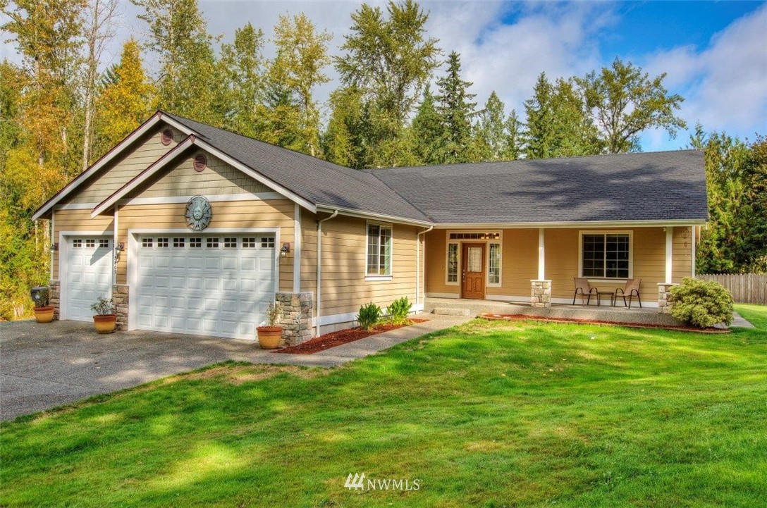 5809 Stringtown Road East Eatonville, WA 98328 - Photo 2 of 28 a front view of a house with swimming pool and garden