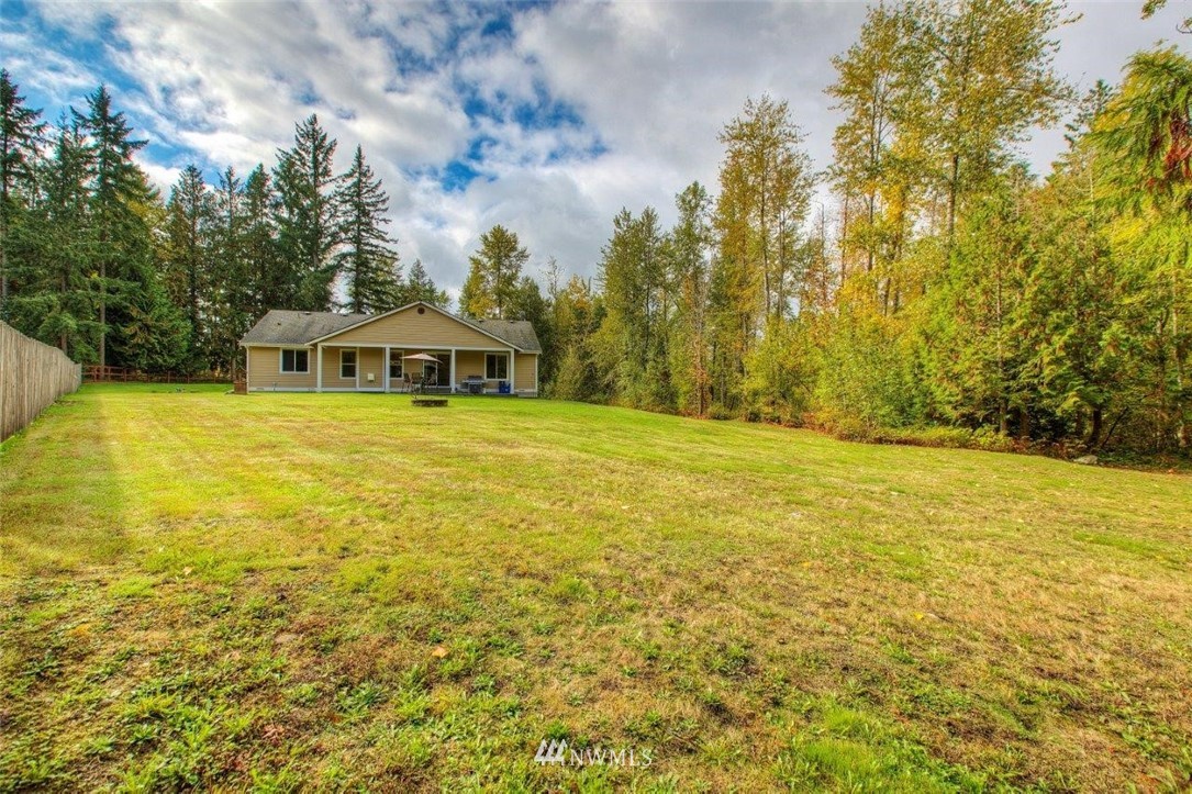 5809 Stringtown Road East Eatonville, WA 98328 - Photo 22 of 28 a view of an ocean swimming pool and trees in the background
