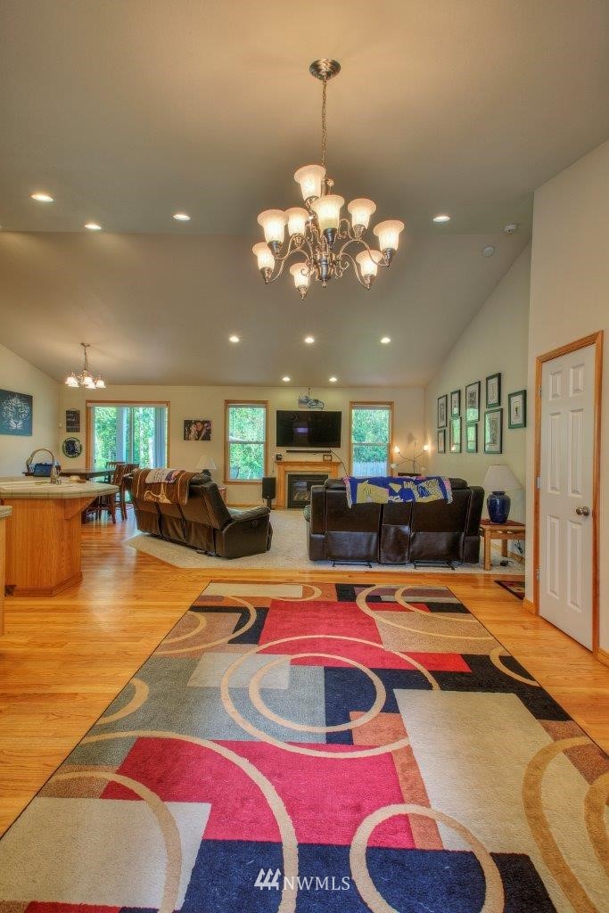 5809 Stringtown Road East Eatonville, WA 98328 - Photo 4 of 28 a living room with dining table a rug and kitchen view