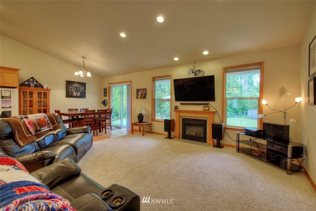 5809 Stringtown Road East Eatonville, WA 98328 - Photo 5 of 28 a living room with furniture a fireplace and a flat screen tv