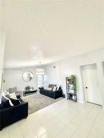 a large bedroom with a bed and a chandelier