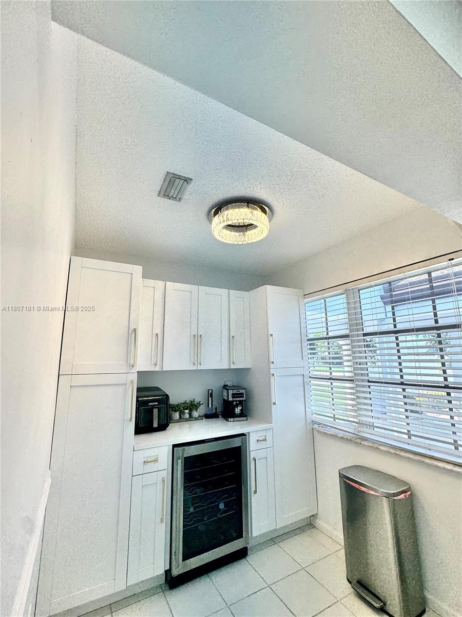 15421 Southwest 158th Street Miami, FL 33187 - Photo 14 of 31 a kitchen with a refrigerator and a stove top oven