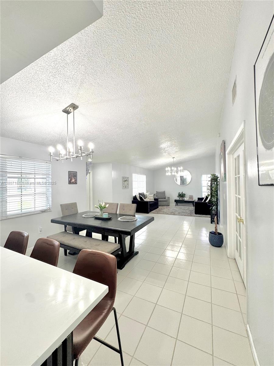 15421 Southwest 158th Street Miami, FL 33187 - Photo 16 of 31 a lobby with furniture and a chandelier