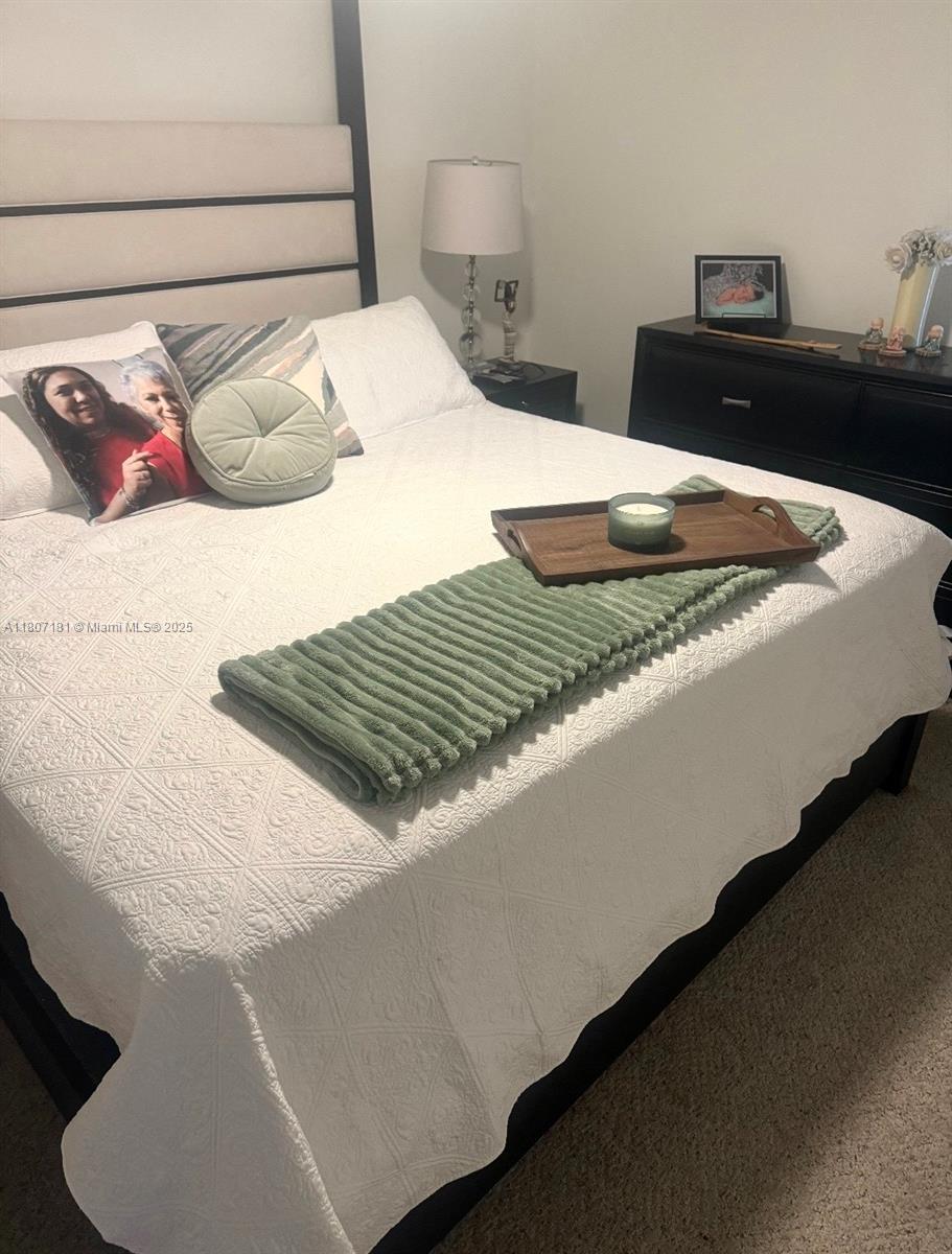 15421 Southwest 158th Street Miami, FL 33187 - Photo 19 of 31 a bedroom with a bed and dresser