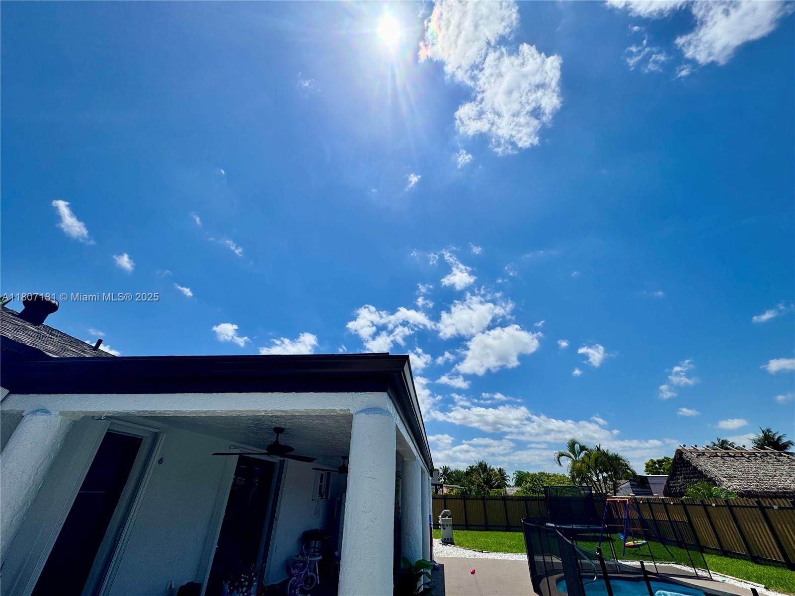 15421 Southwest 158th Street Miami, FL 33187 - Photo 28 of 31 a view of a porch with a table and chairs