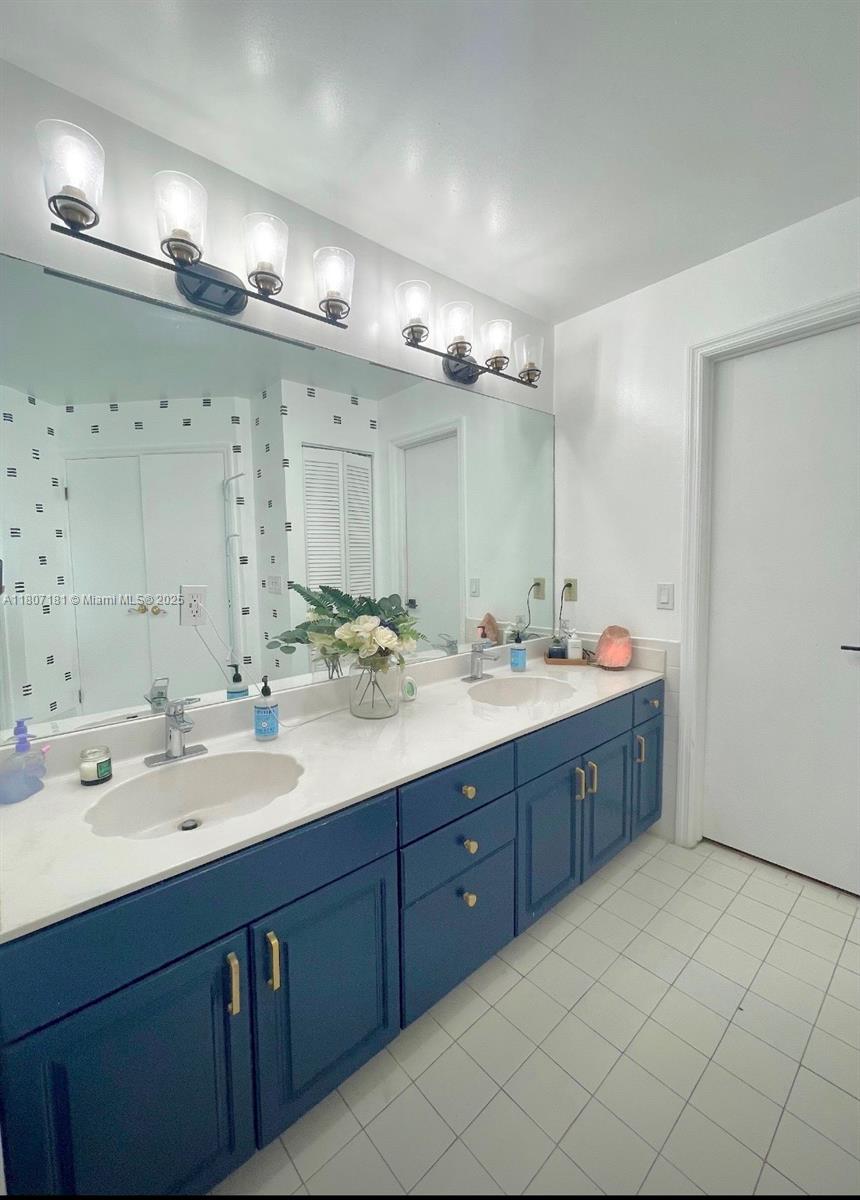 15421 Southwest 158th Street Miami, FL 33187 - Photo 3 of 31 a bathroom with a double vanity sink mirror and double