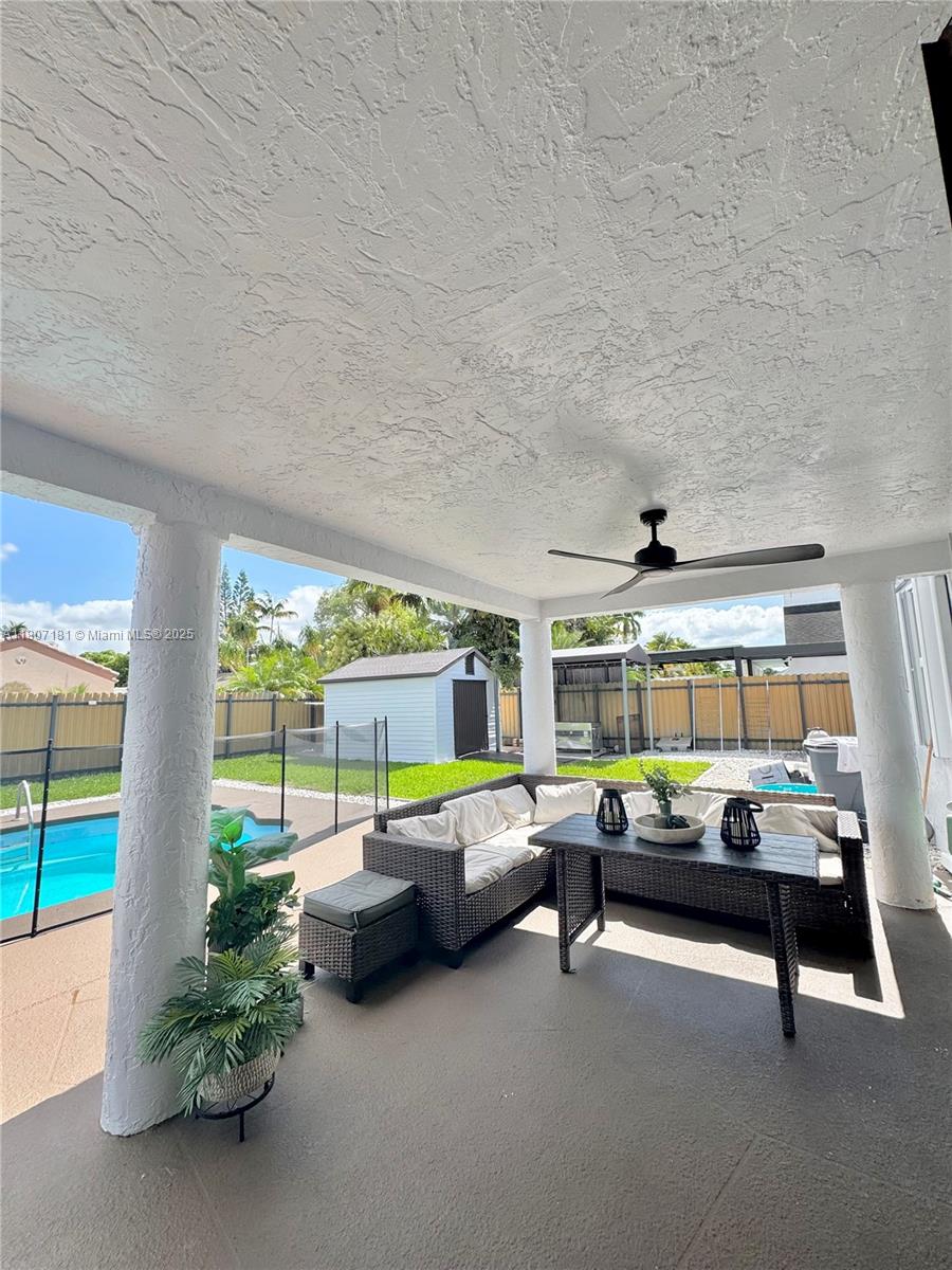15421 Southwest 158th Street Miami, FL 33187 - Photo 4 of 31 a living room with furniture and a large window