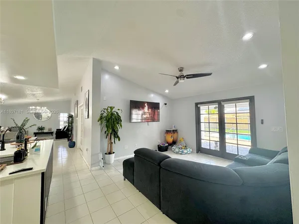 a living room with furniture and a large window