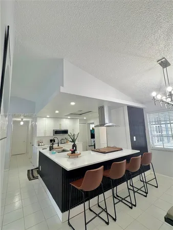 a kitchen with a sink cabinets and window