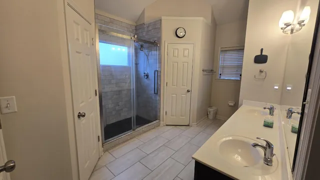 a bathroom with a sink a toilet and shower