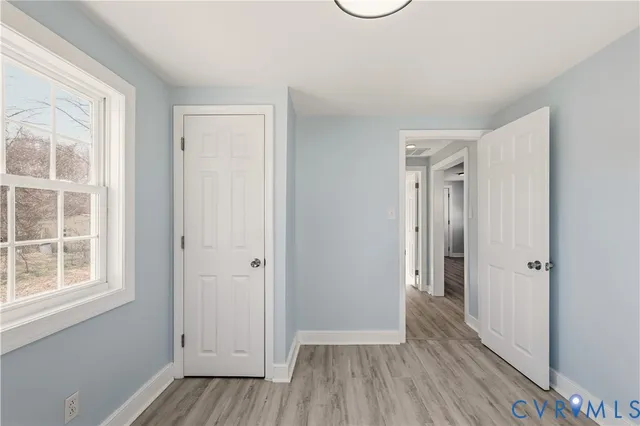 a view of a livingroom with wooden floor and window