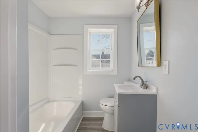 a white bath tub sitting next to a white sink