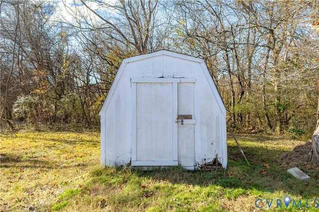 a view of a backyard with large trees