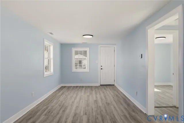 wooden floor in an empty room with a window