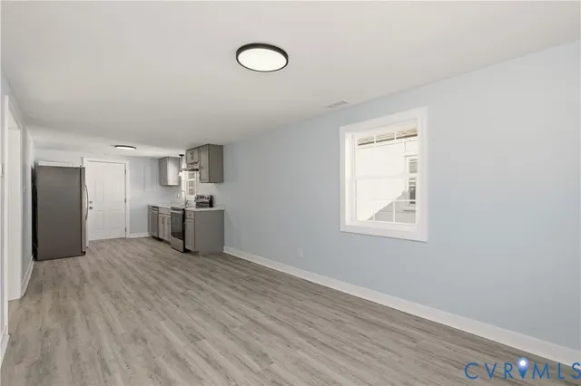 a view of a kitchen with a sink and dishwasher wooden floor