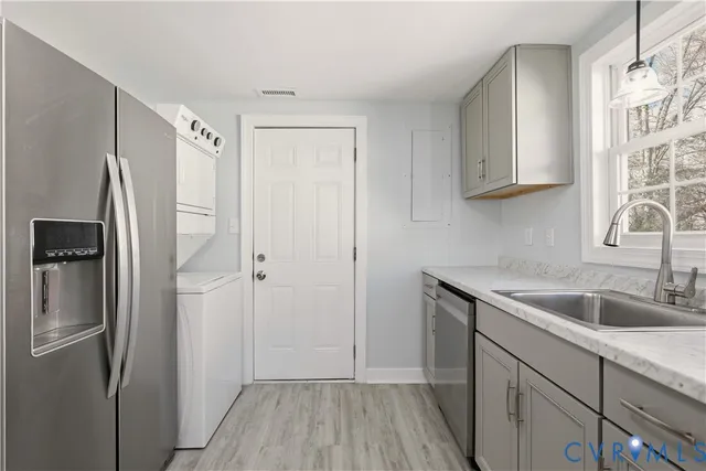 a kitchen with a refrigerator sink and cabinets