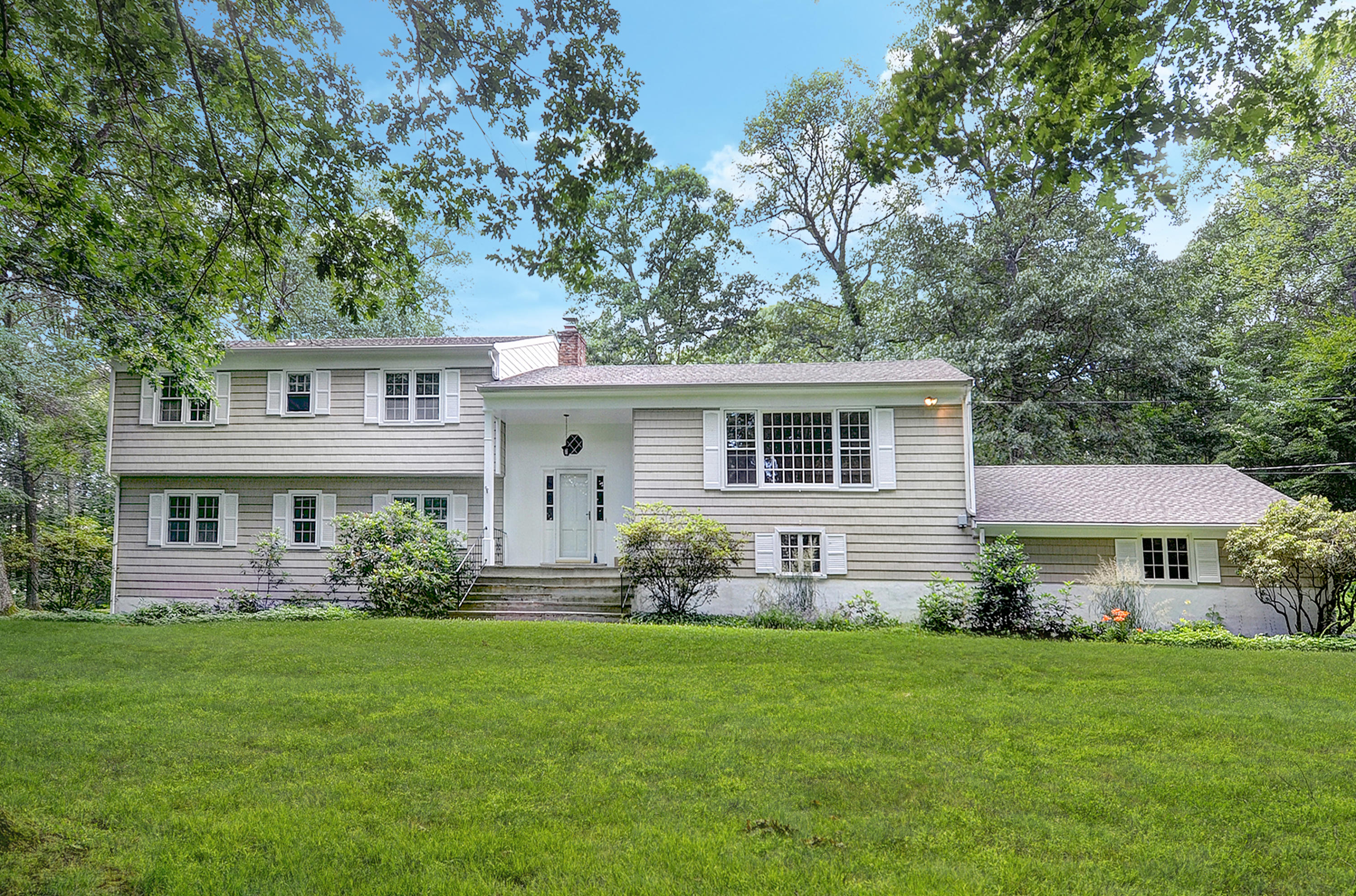 154 South Bald Hill Road New Canaan, CT 06840 - Photo 1 of 21 a front view of house with yard and green space