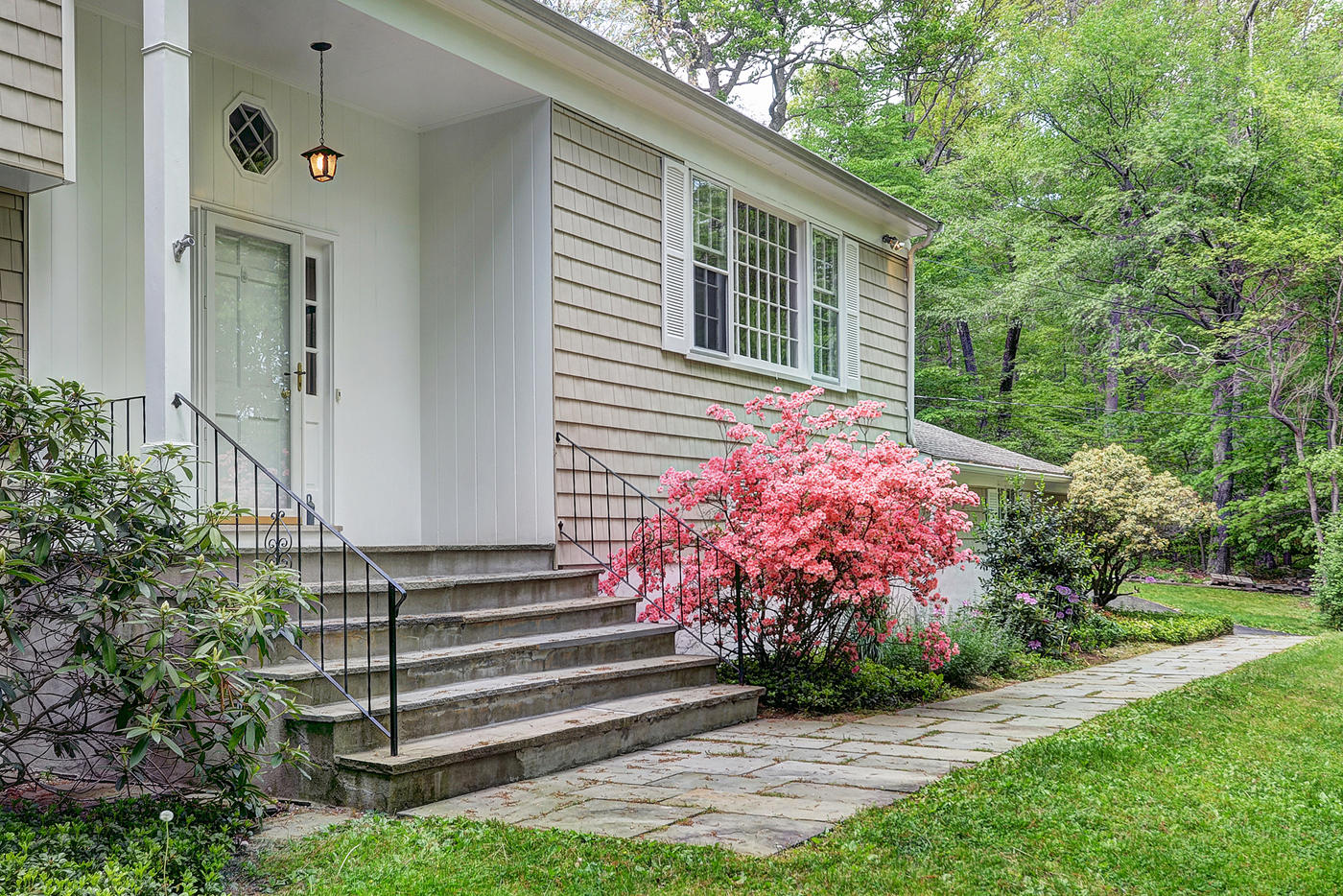 154 South Bald Hill Road New Canaan, CT 06840 - Photo 2 of 21 a front view of a house with garden
