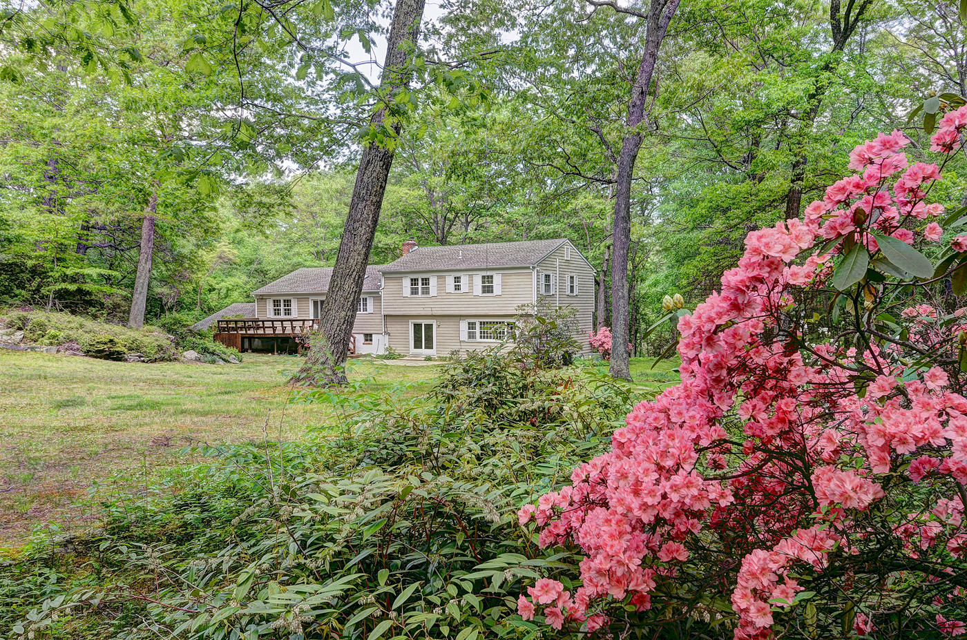 154 South Bald Hill Road New Canaan, CT 06840 - Photo 3 of 21 a view of a house with a yard and garden