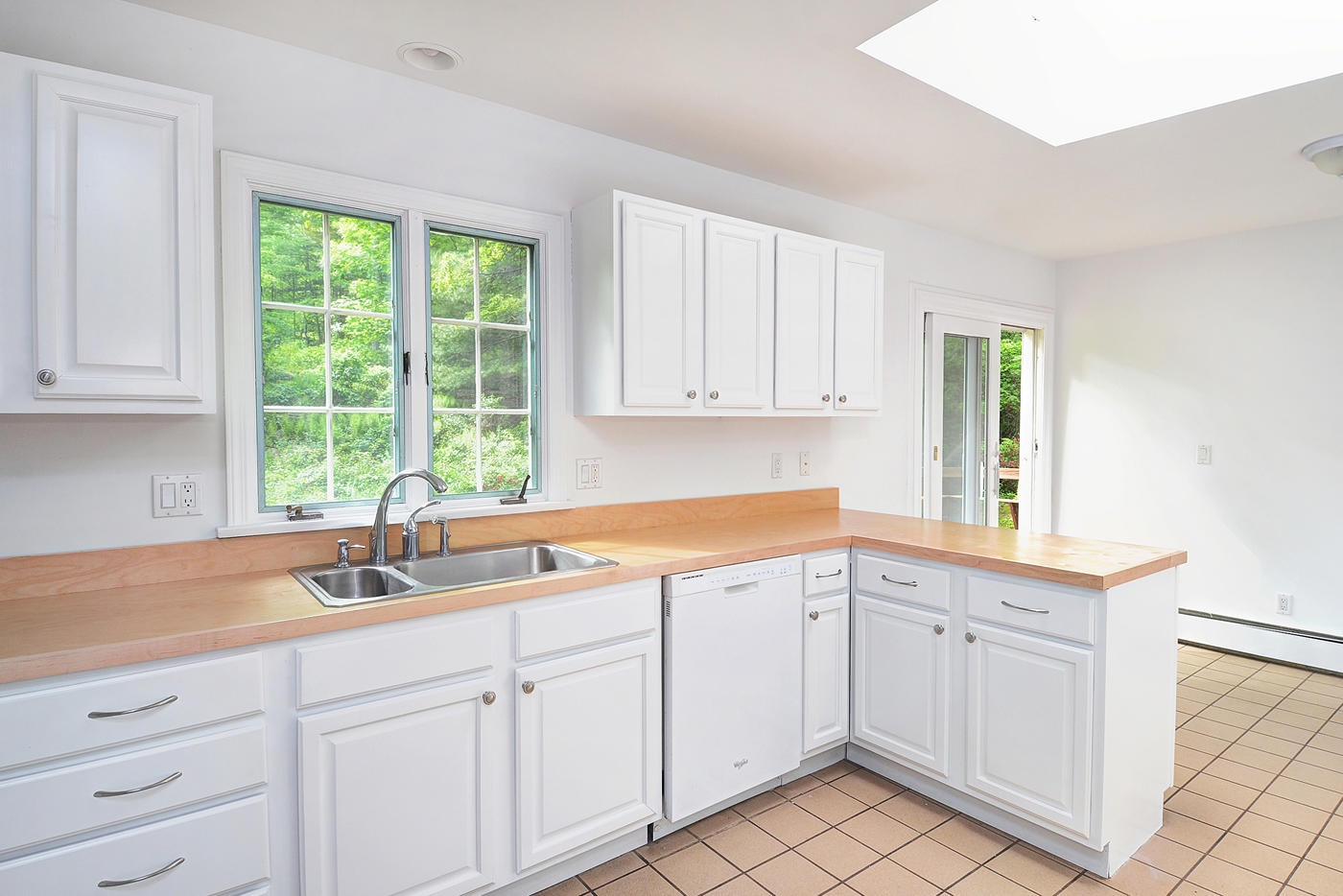 154 South Bald Hill Road New Canaan, CT 06840 - Photo 7 of 21 a kitchen with white cabinets and a sink