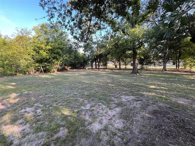 a view of empty field with trees