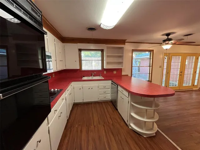 a spacious bathroom with a granite countertop sink and a mirror