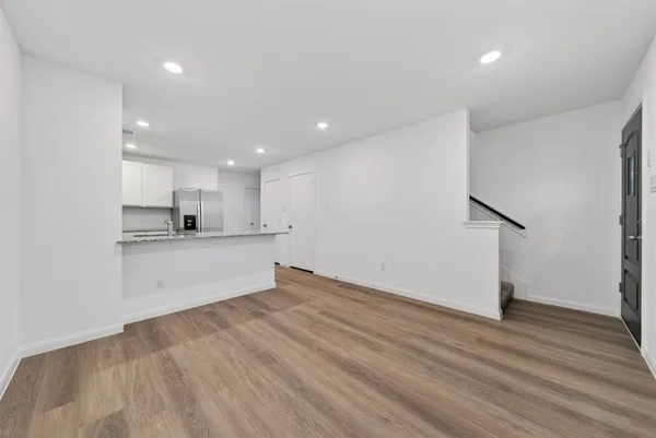 a view of kitchen with wooden floor and electronic appliances
