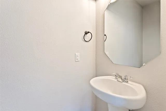 a bathroom with a sink and mirror