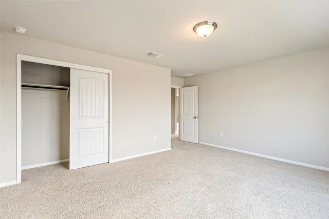 a view of an empty room and a window