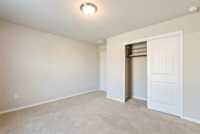 an empty room with closet area