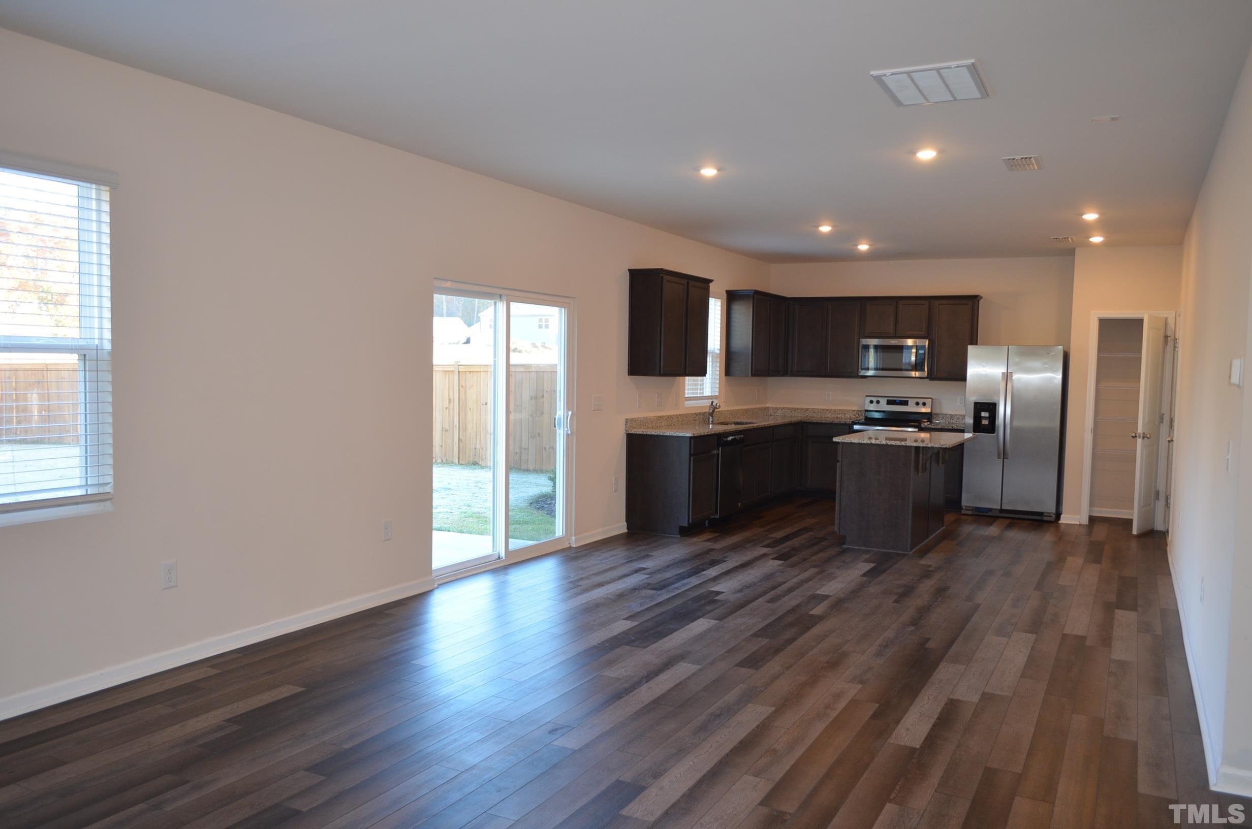 3537 Pinnacle Peak Drive Raleigh, NC 27604 - Photo 18 of 41 an open kitchen with wooden floor and stainless steel appliances
