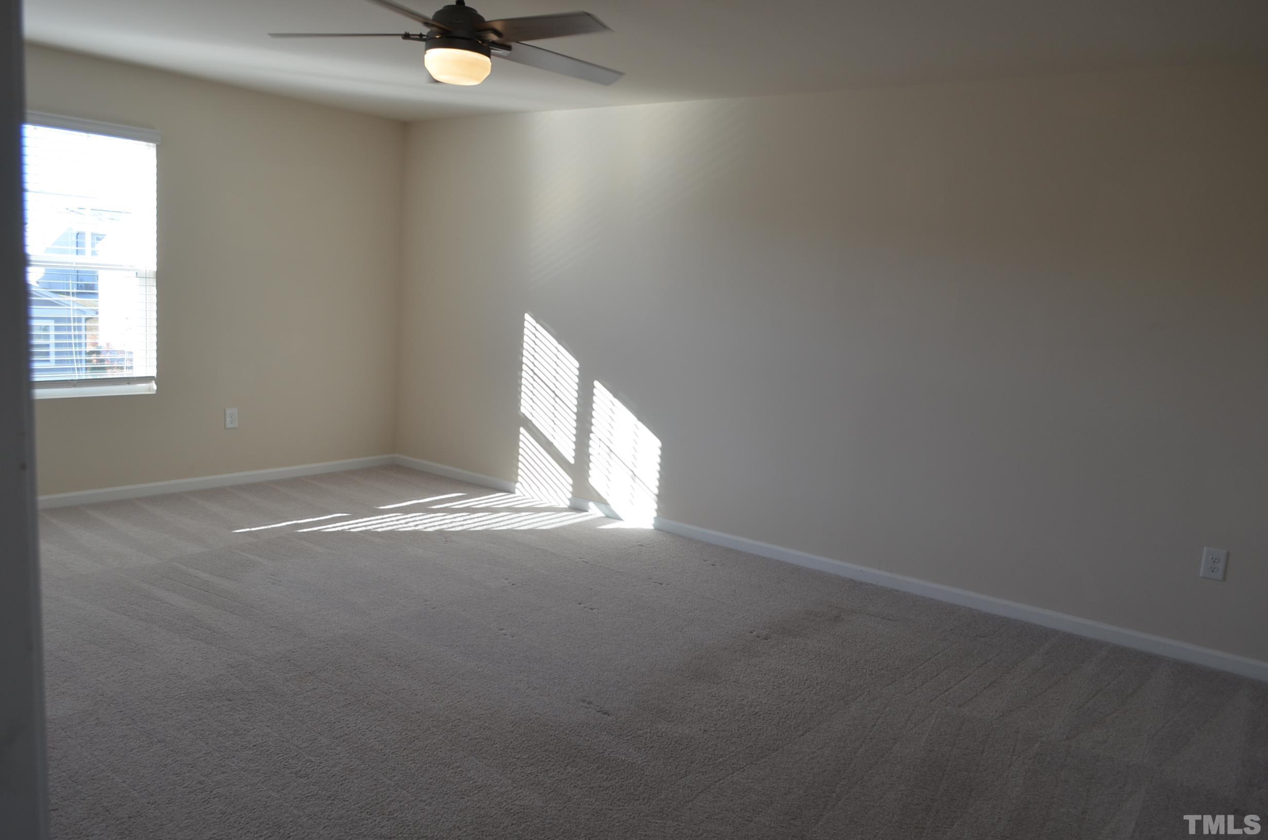 3537 Pinnacle Peak Drive Raleigh, NC 27604 - Photo 25 of 41 an empty room with a window and a fan