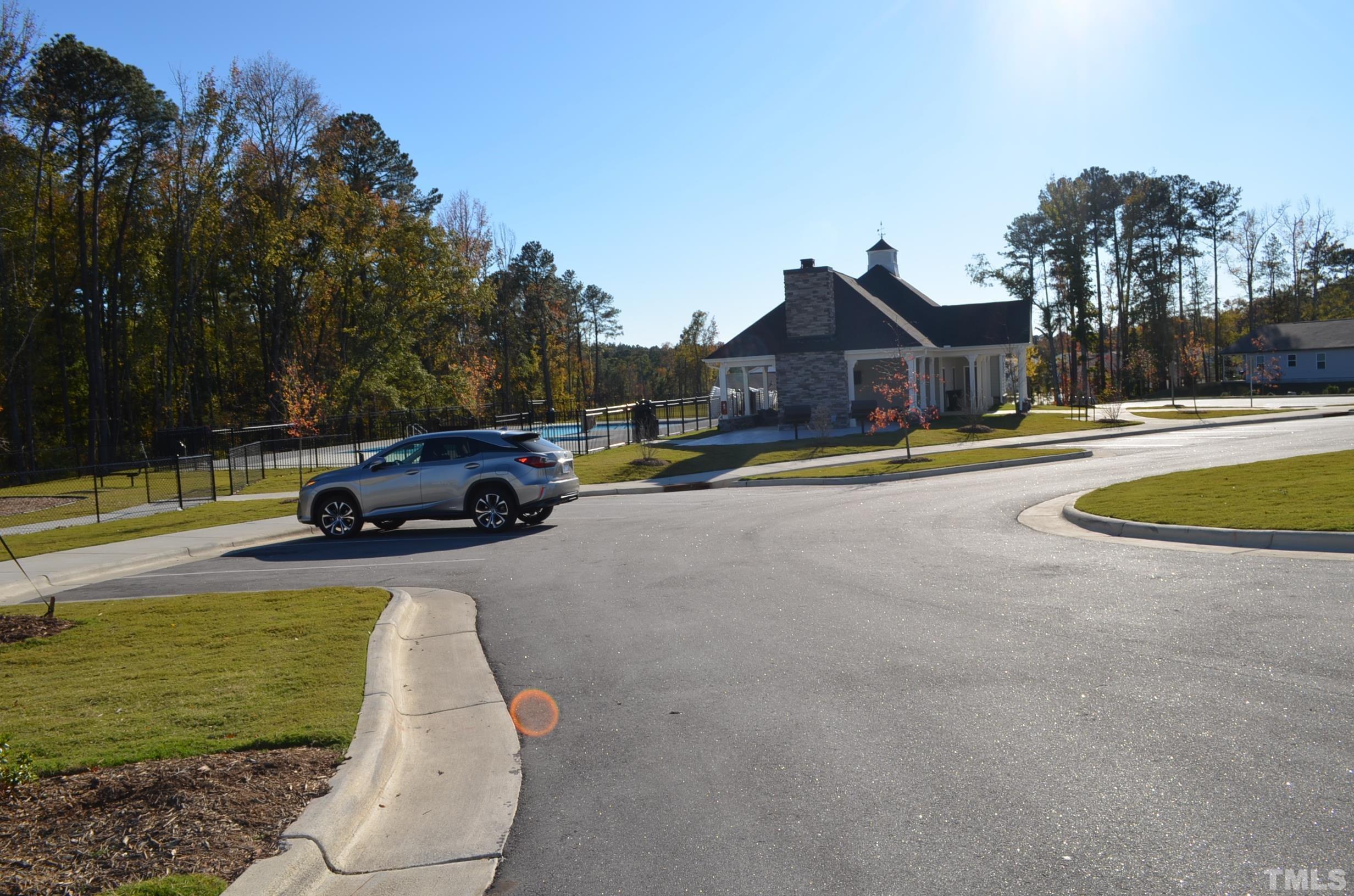 3537 Pinnacle Peak Drive Raleigh, NC 27604 - Photo 37 of 41 a view of a white house with a swimming pool and a yard