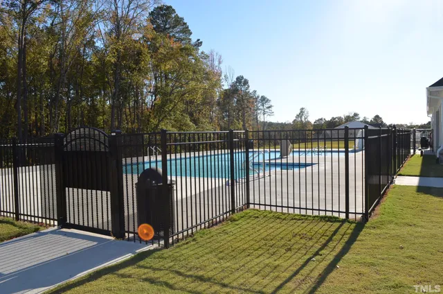 a view of a balcony with floor to ceiling window and wooden fence