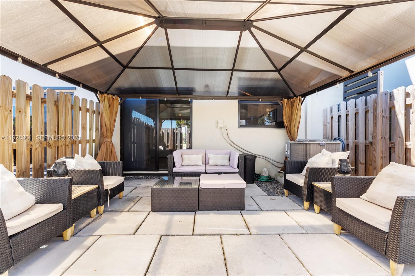 9917 Southwest 228th Terrace Miami, FL 33190 - Photo 11 of 36 a building outdoor space with patio furniture and potted plants