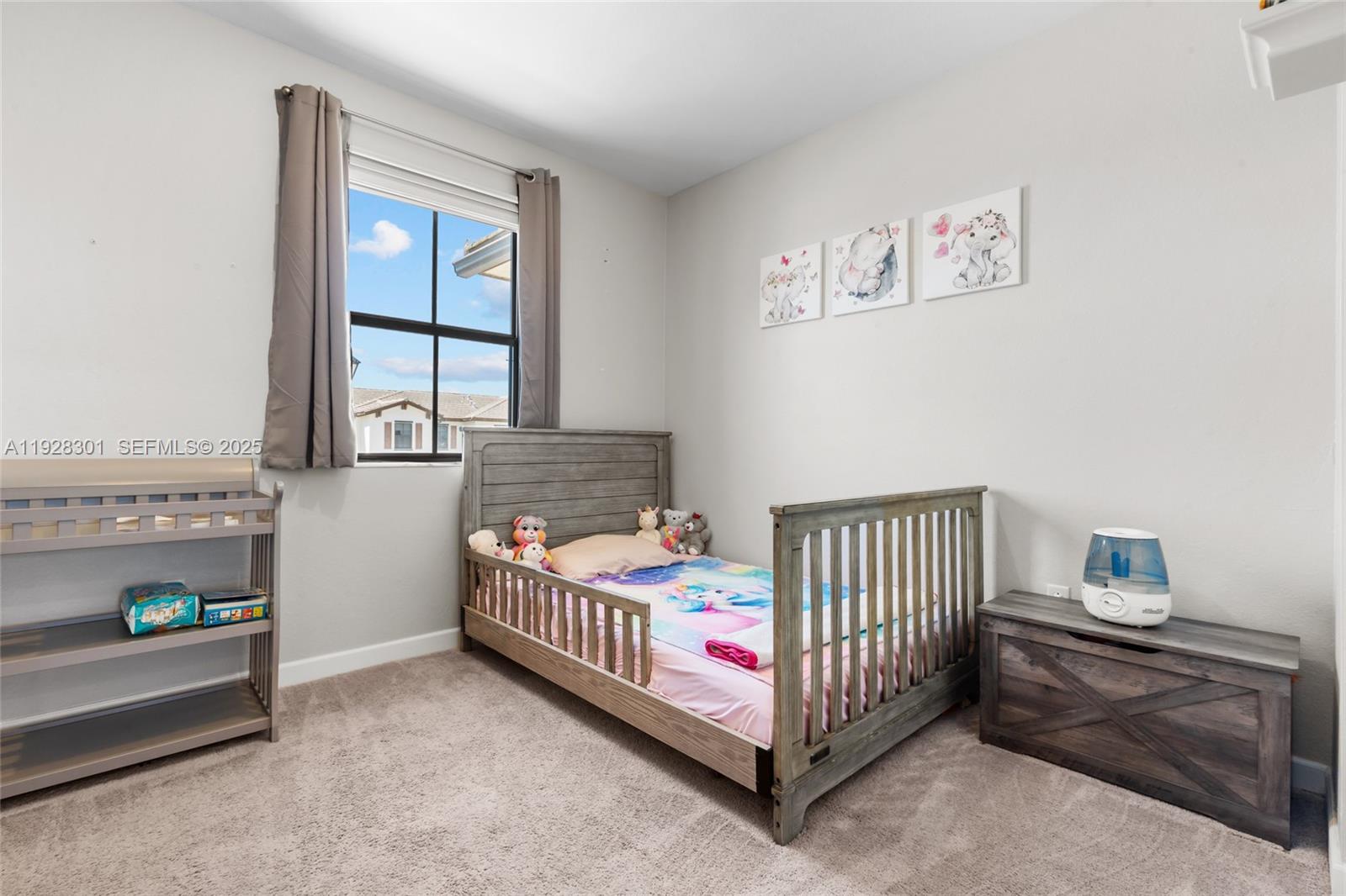 9917 Southwest 228th Terrace Miami, FL 33190 - Photo 15 of 36 a bedroom with a bed and window