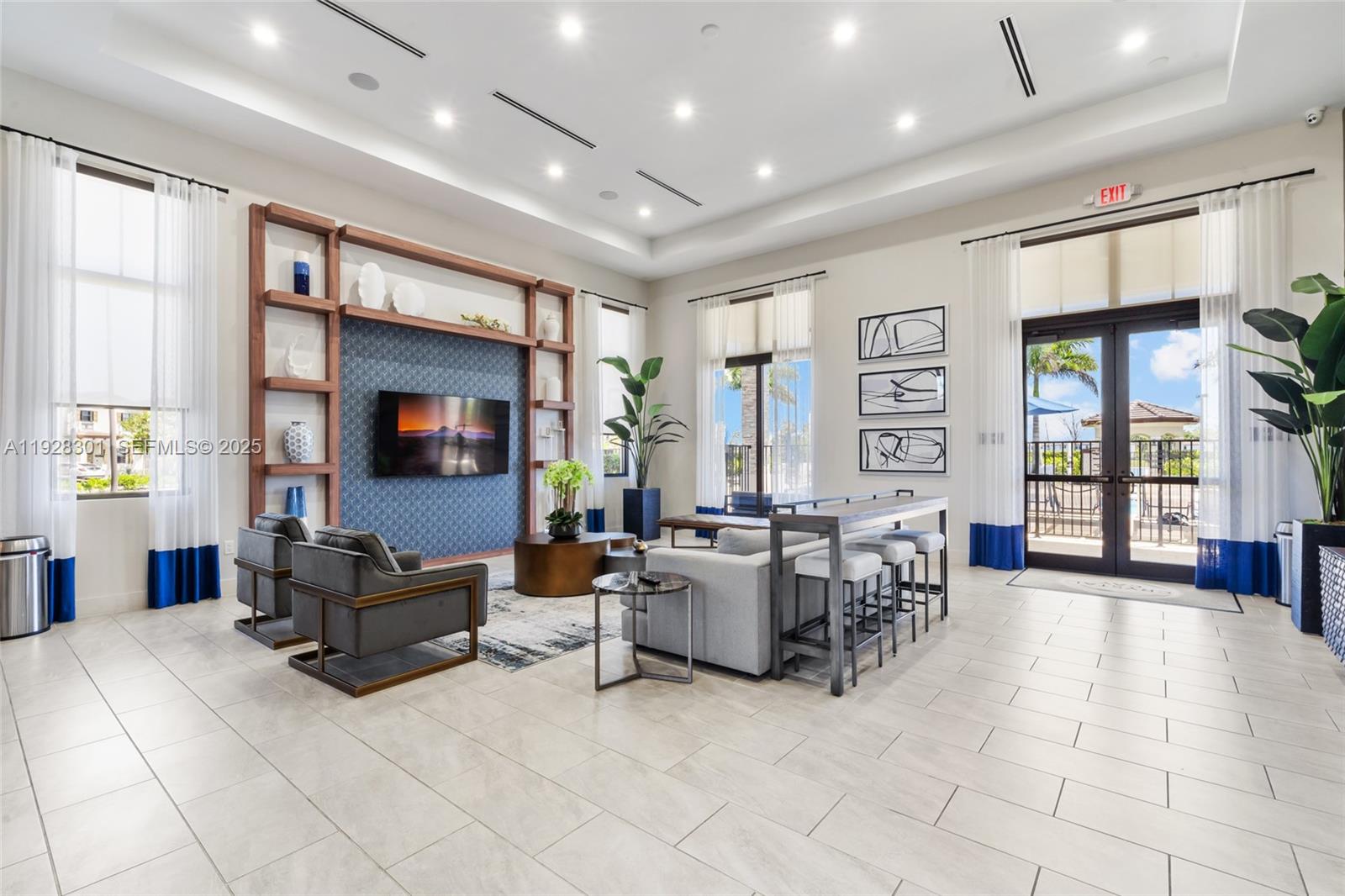 9917 Southwest 228th Terrace Miami, FL 33190 - Photo 19 of 36 a living room with furniture and large windows