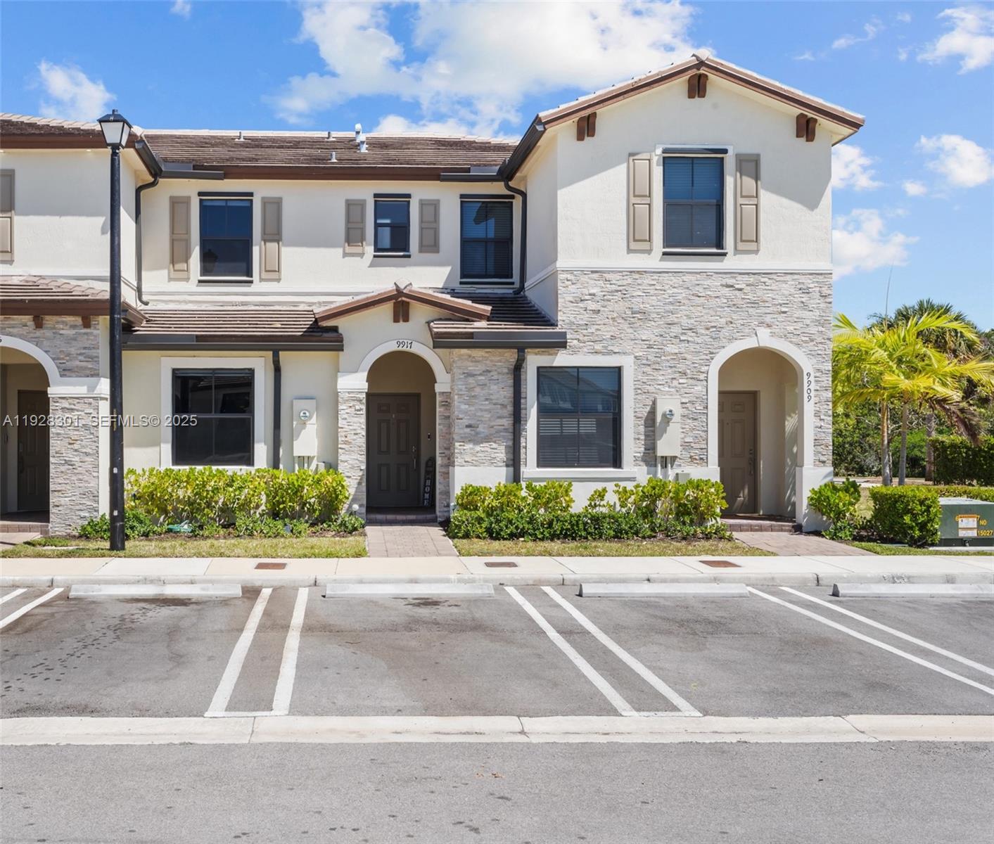 9917 Southwest 228th Terrace Miami, FL 33190 - Photo 2 of 36 a front view of a house with garden
