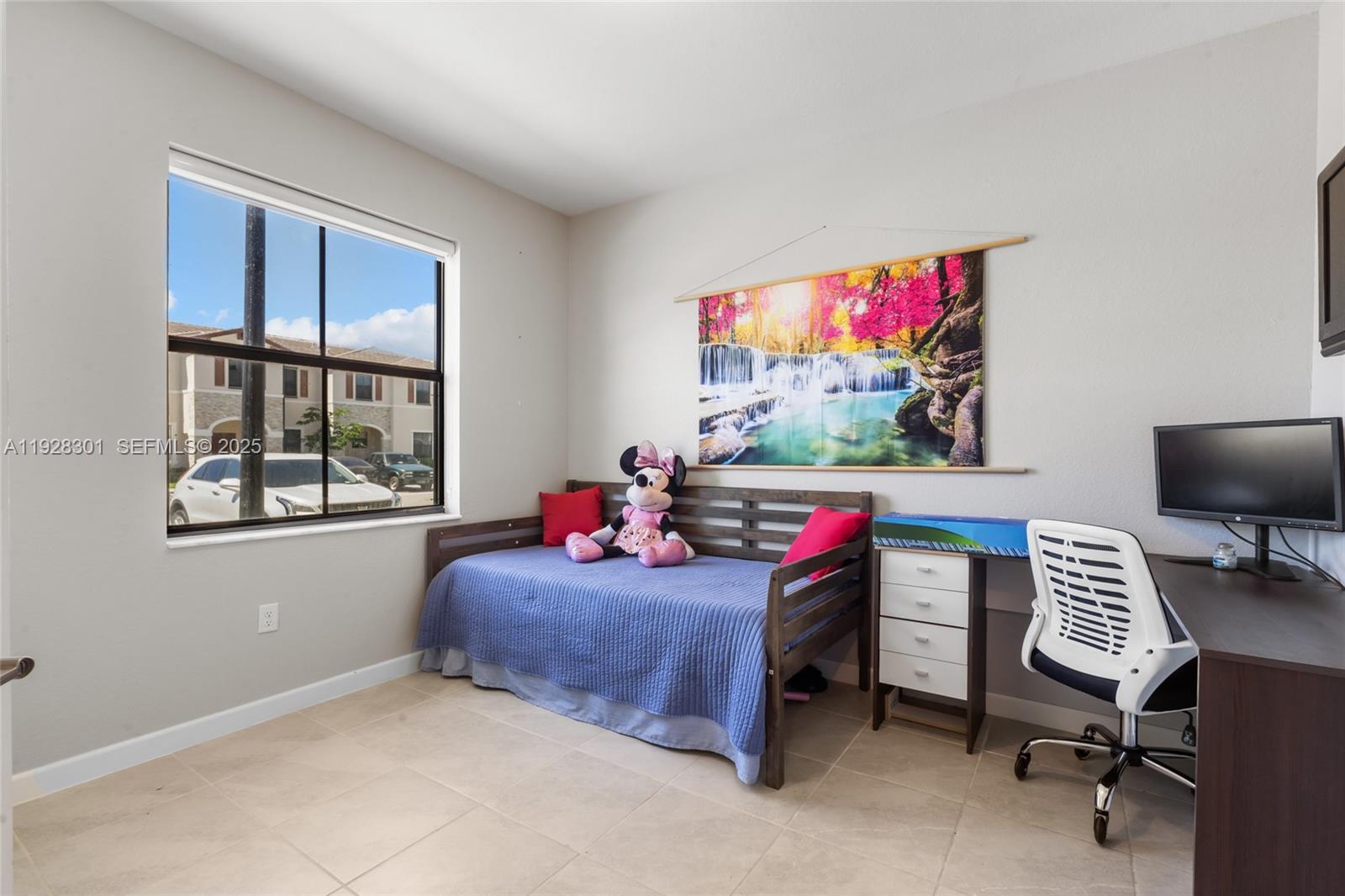 9917 Southwest 228th Terrace Miami, FL 33190 - Photo 25 of 36 a living room with furniture and a flat screen tv