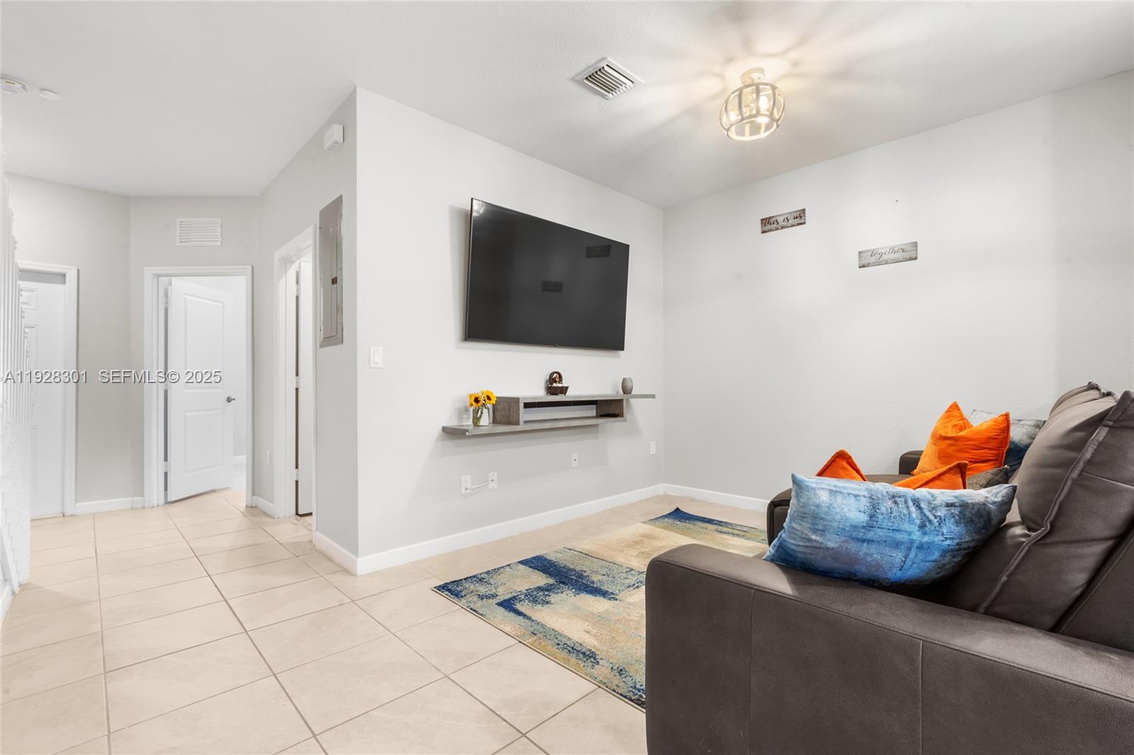 9917 Southwest 228th Terrace Miami, FL 33190 - Photo 28 of 36 a living room with furniture and a flat screen tv