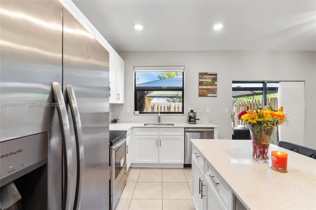 a kitchen with a sink cabinets and appliances