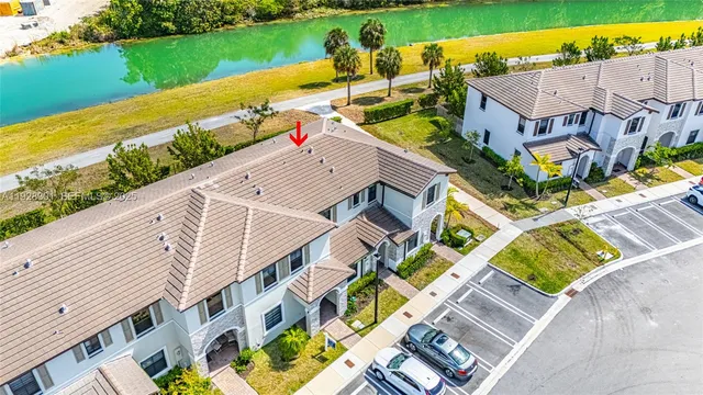 an aerial view of a house with a garden and lake view