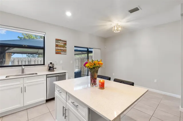 a kitchen with a sink refrigerator and microwave