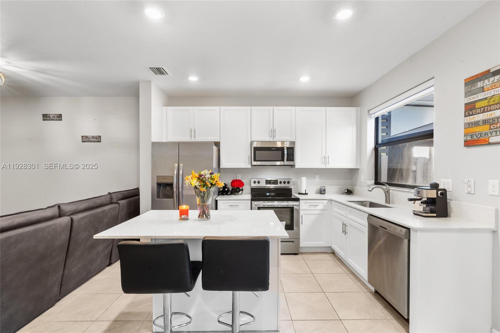 9917 Southwest 228th Terrace Miami, FL 33190 - Photo 8 of 36 a kitchen with stainless steel appliances a sink stove and refrigerator