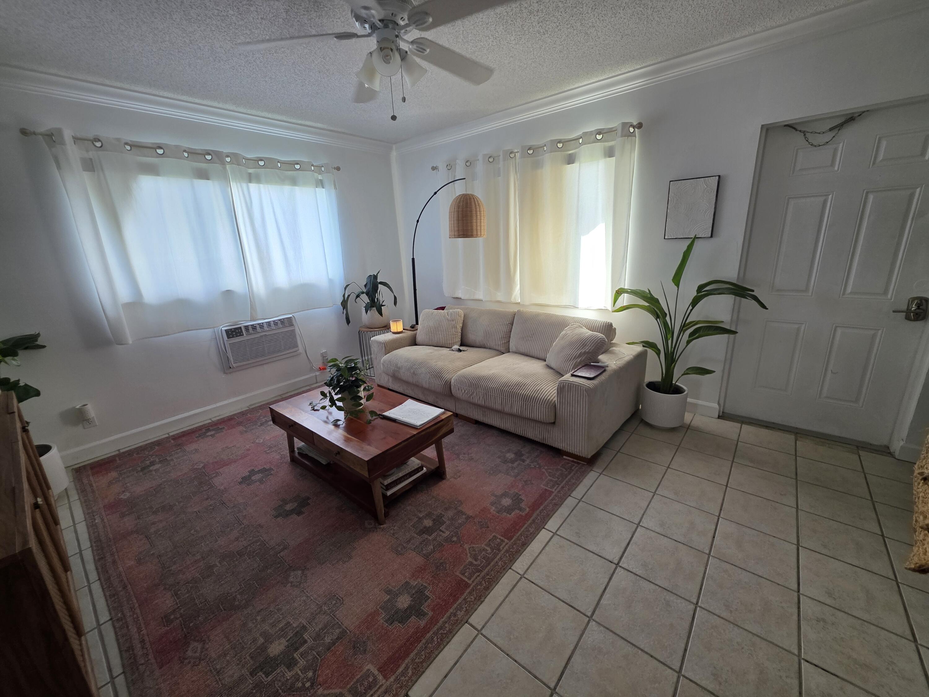 217 Butler Street, Unit 1 West Palm Beach, FL 33407 - Photo 5 of 9 a living room with patio furniture and a window