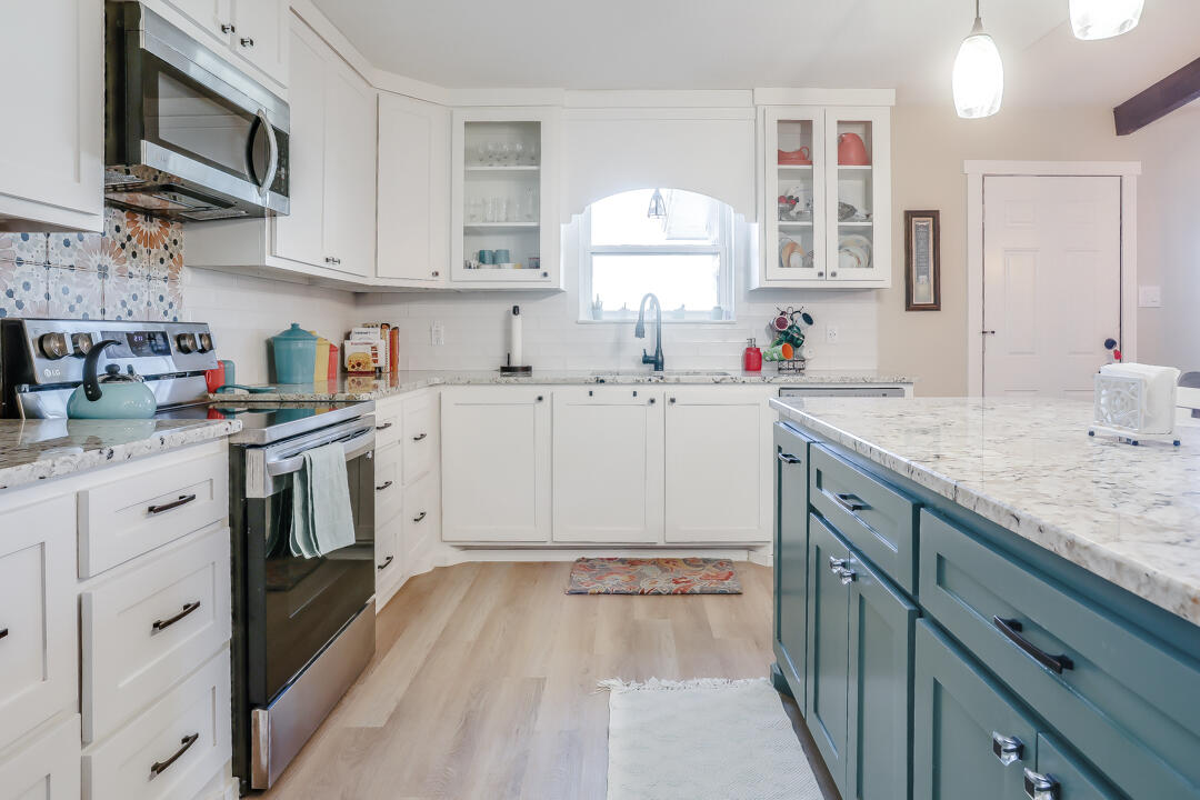 4306 57th Street Lubbock, TX 79413 - Photo 11 of 23 a kitchen with a sink stove top oven and cabinets